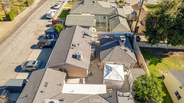 an aerial view of a house with swimming pool and patio