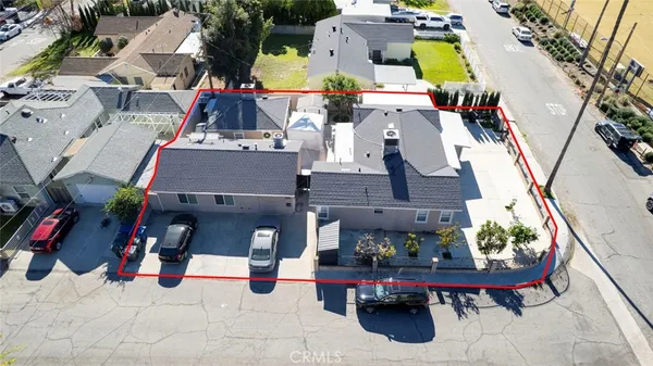an aerial view of a house with swimming pool and sitting area