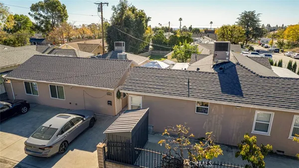 a view of a patio with couches table and chairs with potted plants