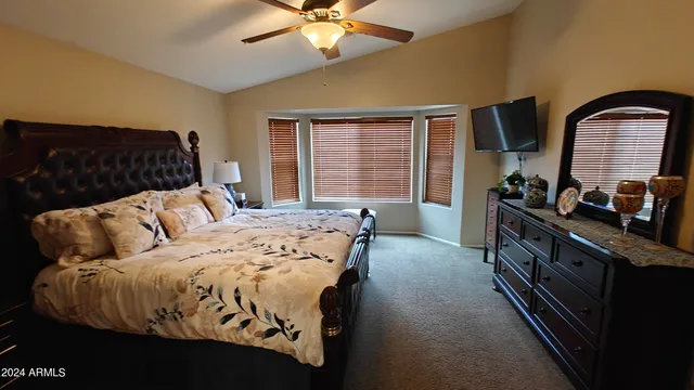 a bedroom with a bed and a chandelier