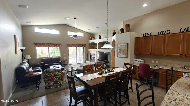 a kitchen with a stove a refrigerator a sink dishwasher with a dining table and chairs