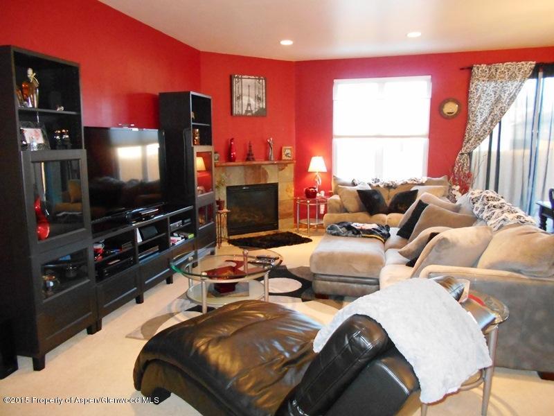 1068 East 17th Street Rifle, CO 81650 - Photo 2 of 9 a bedroom with two beds and a flat screen tv
