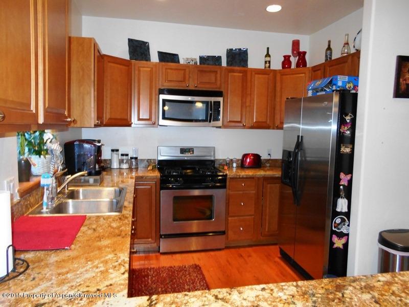 1068 East 17th Street Rifle, CO 81650 - Photo 4 of 9 a kitchen with stainless steel appliances granite countertop a refrigerator sink and stove