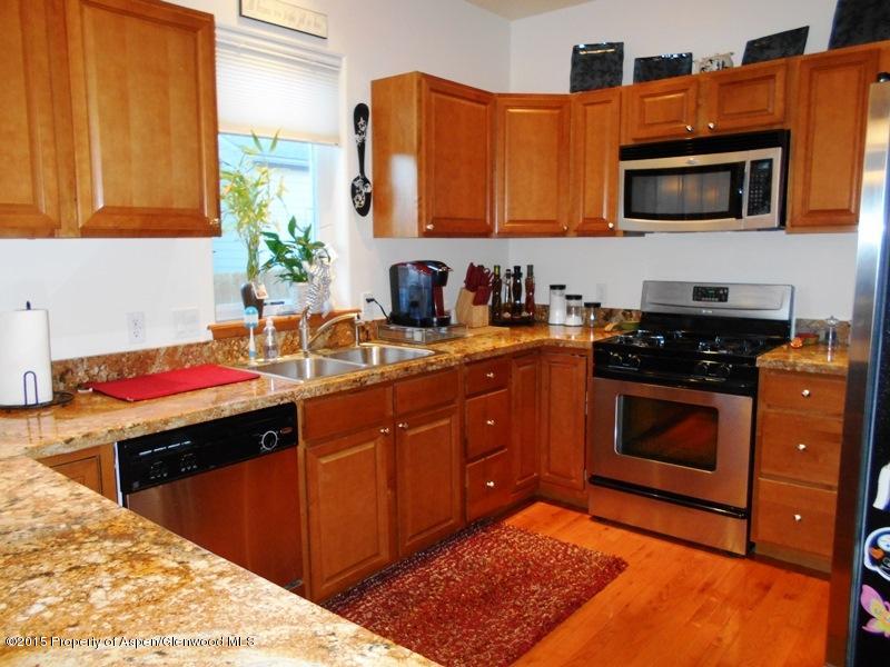 1068 East 17th Street Rifle, CO 81650 - Photo 5 of 9 a kitchen with a sink stove and microwave