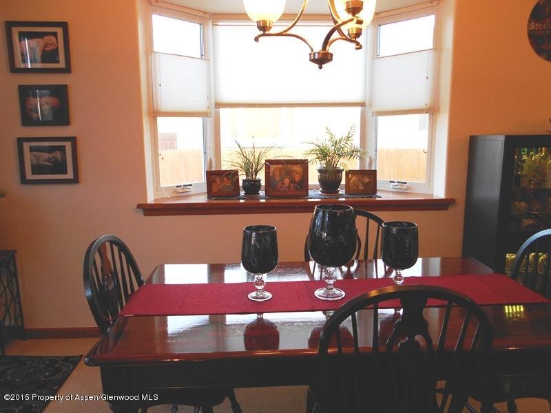 1068 East 17th Street Rifle, CO 81650 - Photo 7 of 9 a view of a dining room with furniture large windows and wooden floor