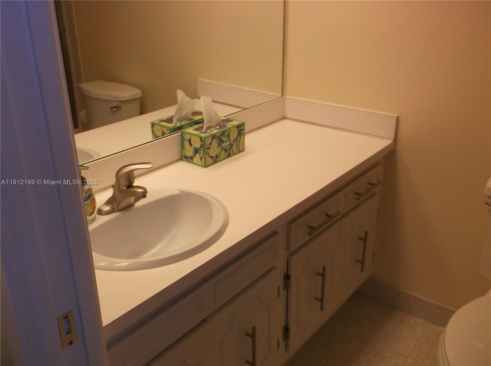 3080 North Course Drive, Unit 209 Pompano Beach, FL 33069 - Photo 20 of 35 a bathroom with a sink and a mirror