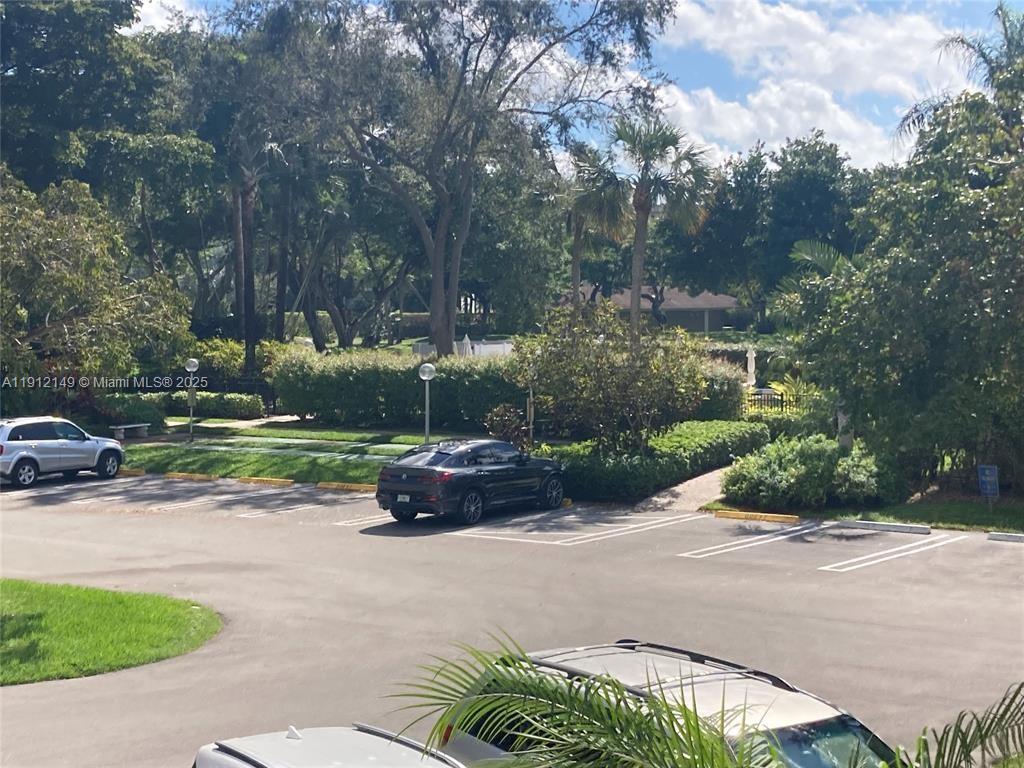 3080 North Course Drive, Unit 209 Pompano Beach, FL 33069 - Photo 26 of 35 a view of backyard with outdoor seating and green space
