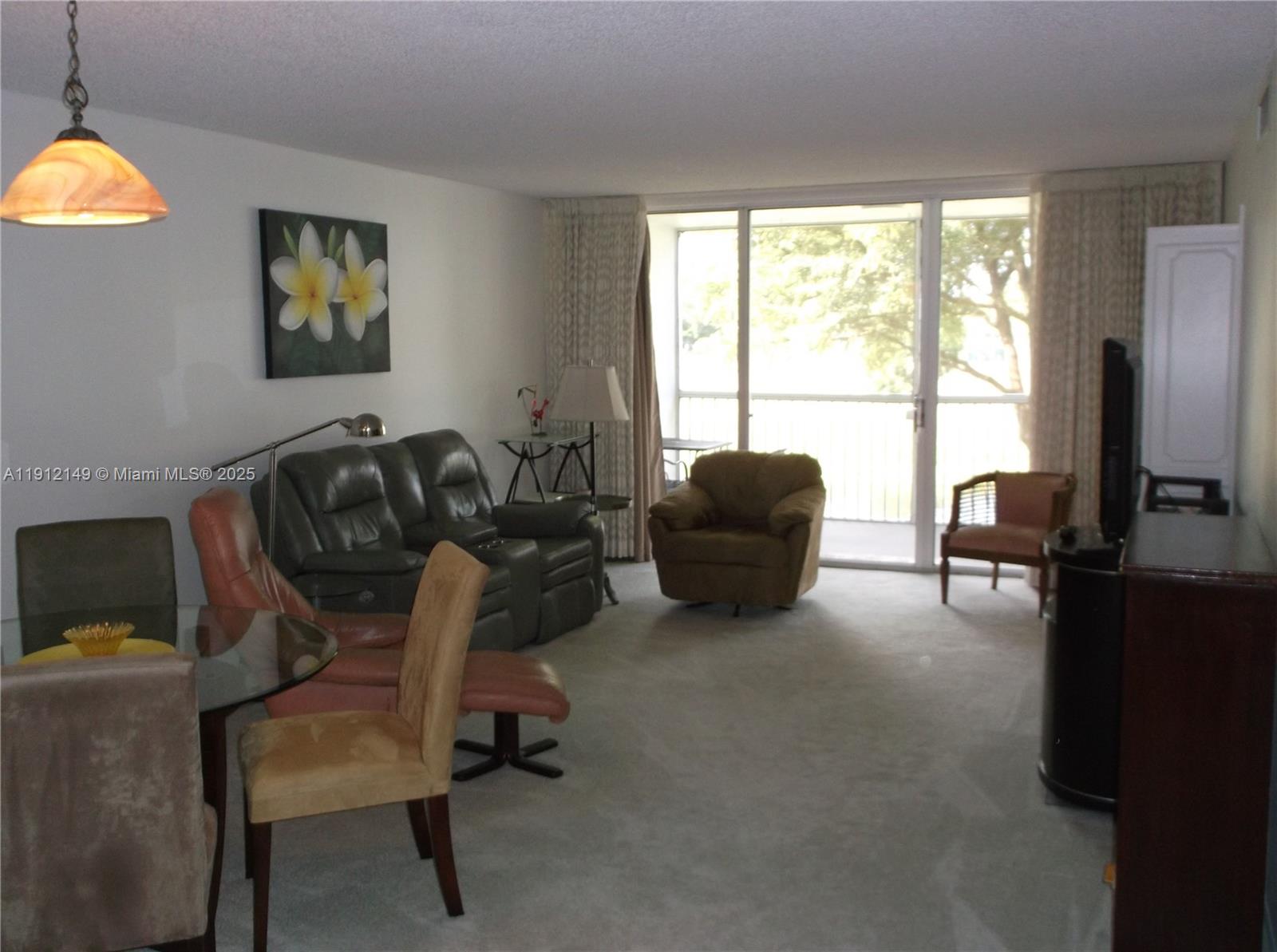 3080 North Course Drive, Unit 209 Pompano Beach, FL 33069 - Photo 3 of 35 a living room with furniture and a flat screen tv