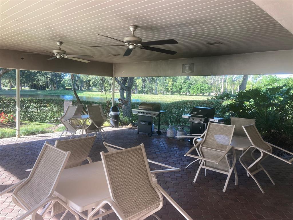 3080 North Course Drive, Unit 209 Pompano Beach, FL 33069 - Photo 31 of 35 a view of a patio with table and chairs