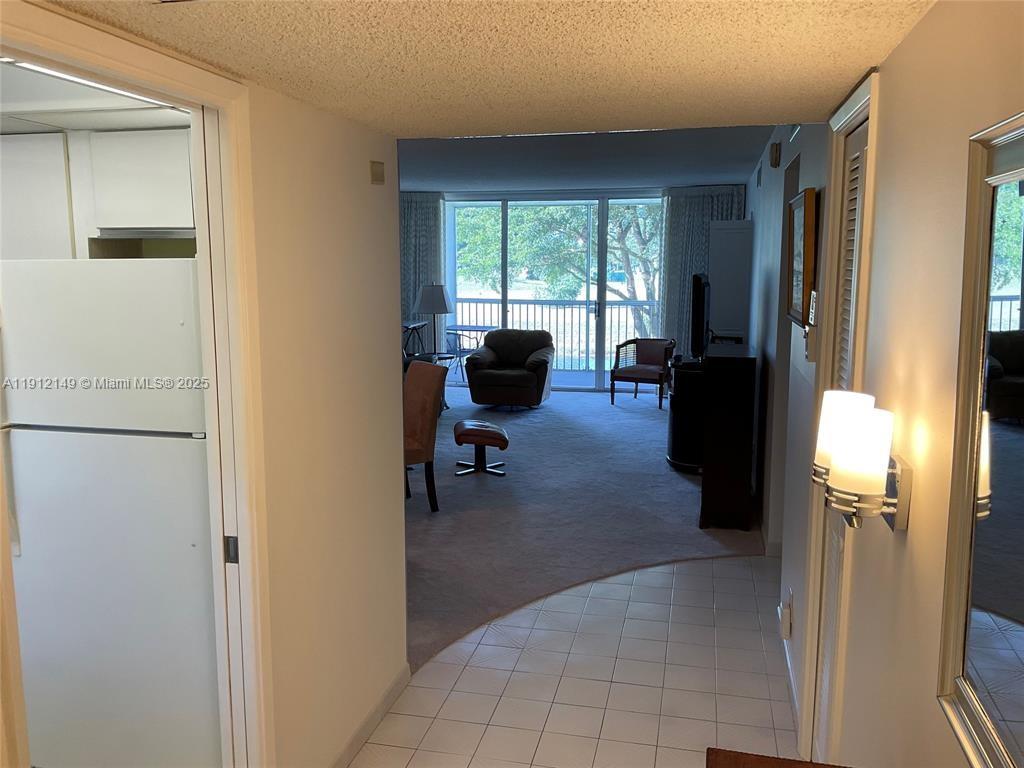 3080 North Course Drive, Unit 209 Pompano Beach, FL 33069 - Photo 6 of 35 a living room with furniture and a large window