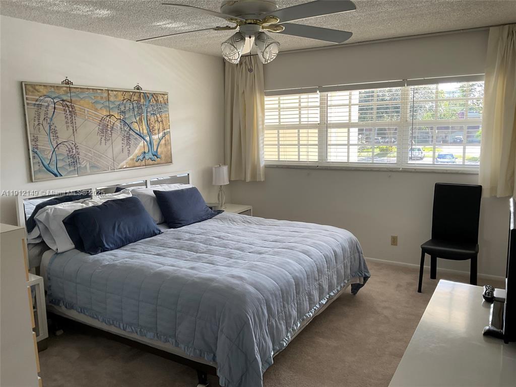 3080 North Course Drive, Unit 209 Pompano Beach, FL 33069 - Photo 9 of 35 a bedroom with a bed and window