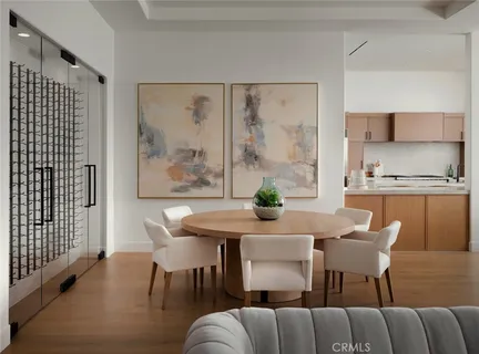 a living room with furniture a flat screen tv and kitchen view