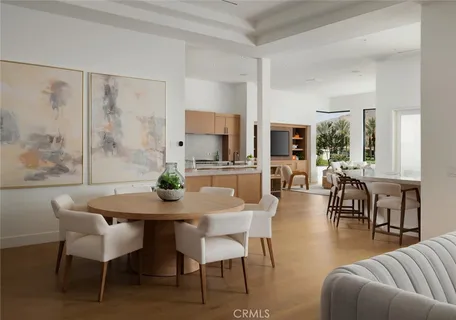 a kitchen with stainless steel appliances granite countertop a table chairs sink and cabinets