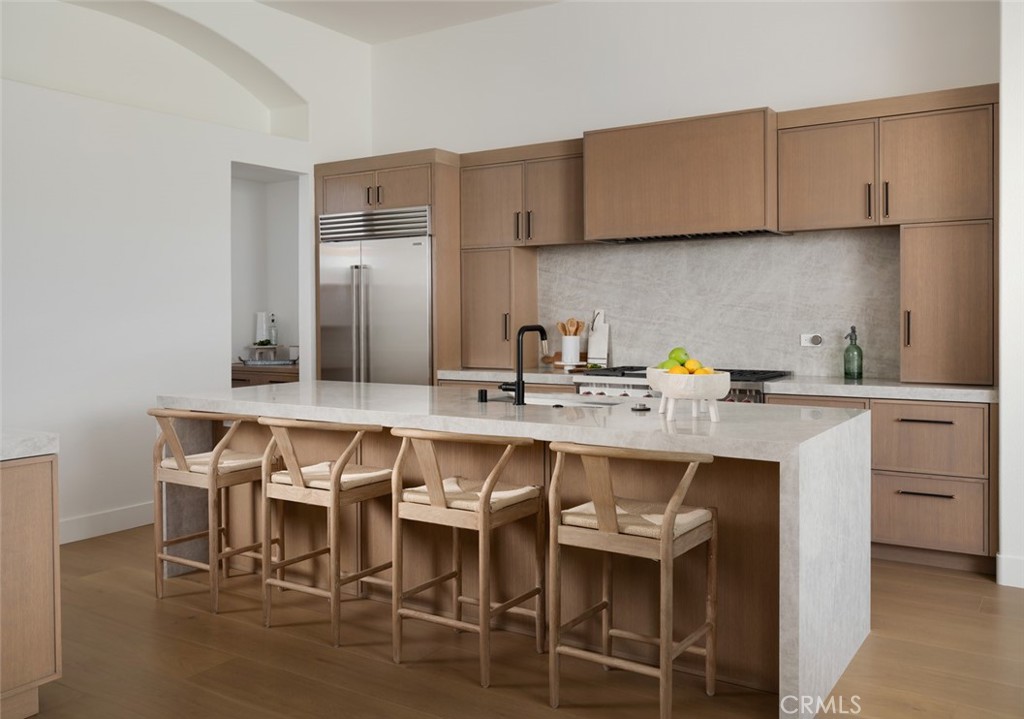 76476 Via Chianti Indian Wells, CA 92210 - Photo 14 of 74 a kitchen with stainless steel appliances granite countertop a table chairs sink and cabinets