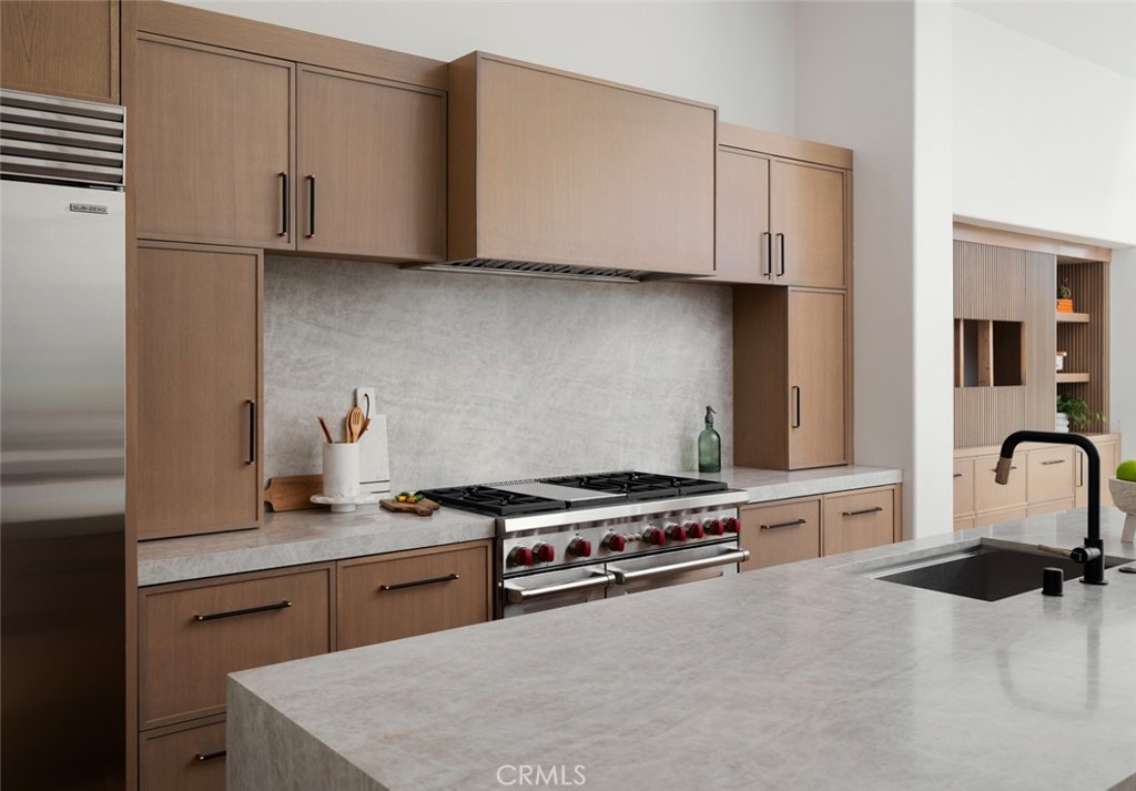 76476 Via Chianti Indian Wells, CA 92210 - Photo 16 of 74 a kitchen with stainless steel appliances granite countertop a stove and a microwave