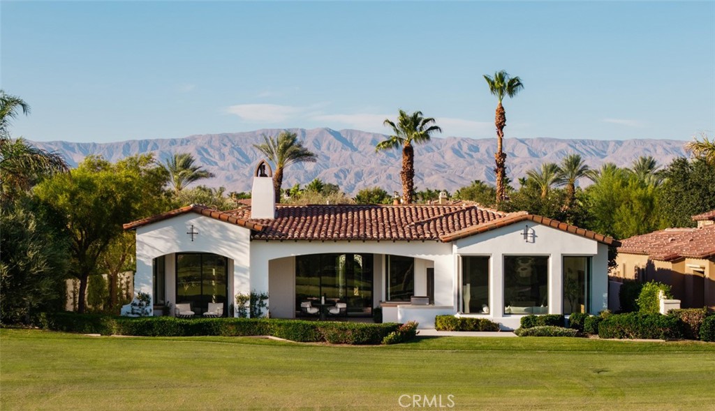 76476 Via Chianti Indian Wells, CA 92210 - Photo 2 of 74 a front view of a house with swimming pool and outdoor seating