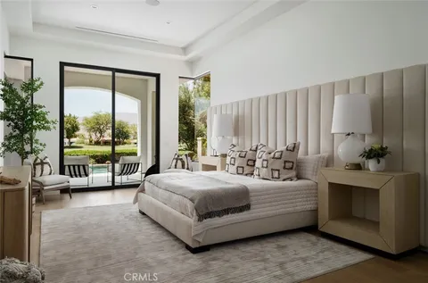 a bedroom with a bed and a dresser next to a window