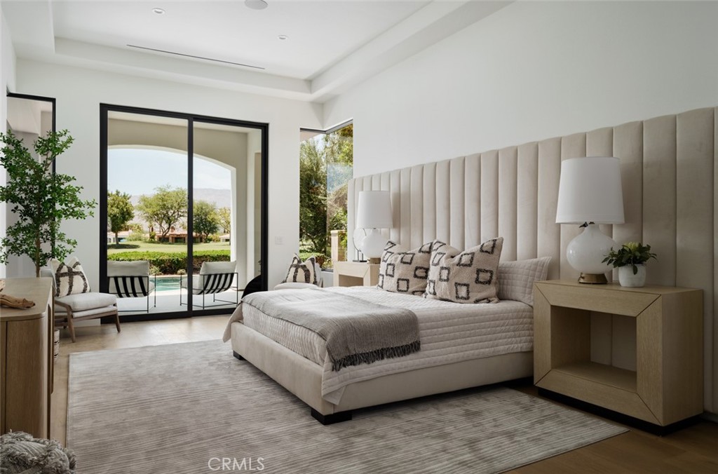 76476 Via Chianti Indian Wells, CA 92210 - Photo 24 of 74 a spacious bedroom with a bed and a large window