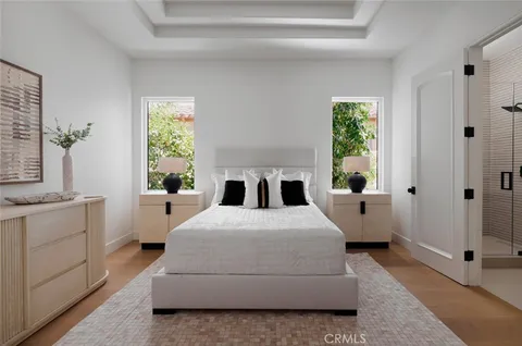 a bedroom with a bed and a large window