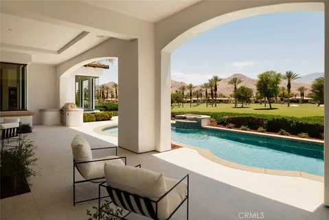 a view of a swimming pool and lounge chairs