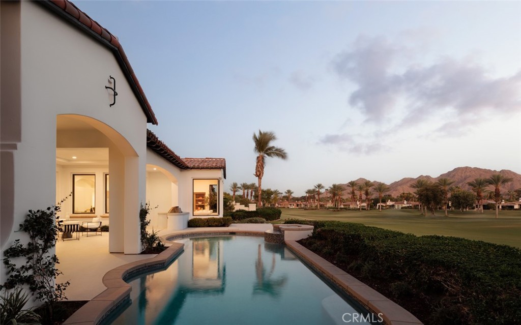 76476 Via Chianti Indian Wells, CA 92210 - Photo 45 of 74 a view of a house with a swimming pool and sitting area