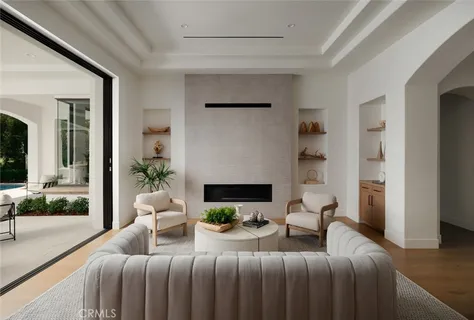 a living room with furniture a flat screen tv and kitchen view