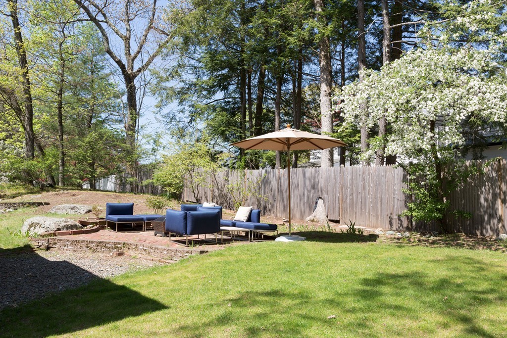 64 Bonad Road Newton, MA 02465 - Photo 16 of 16 a view of swimming pool with a table and chairs under an umbrella