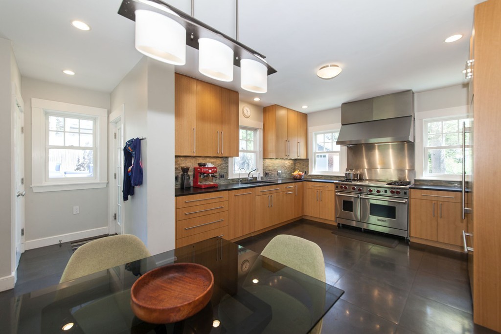 64 Bonad Road Newton, MA 02465 - Photo 8 of 16 a kitchen with stainless steel appliances granite countertop a sink a stove a refrigerator cabinets and a dining table