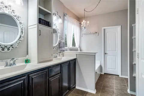 a bathroom with a double vanity sink and a mirror