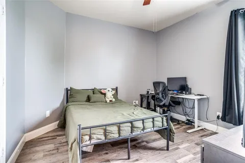 a bedroom with a bed and a desk