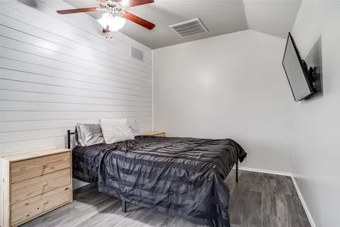 a bedroom with a bed and cabinet
