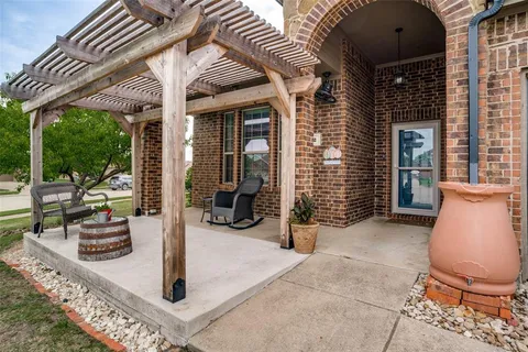 a view of a house with backyard porch and sitting area