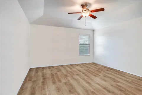 a view of a room with a ceiling fan and a window
