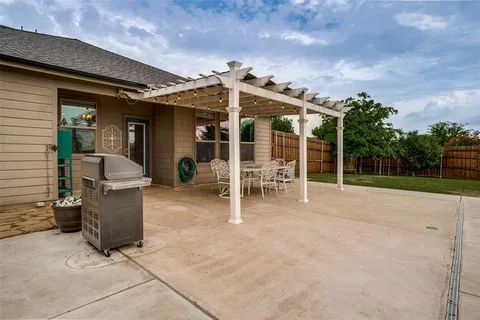 a view of a patio with table and chairs and potted plants