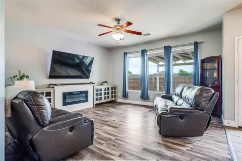 a living room with furniture fireplace and flat screen tv