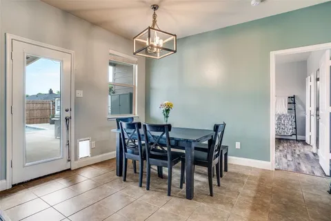 a view of a dining room with furniture and chandelier