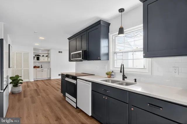 a kitchen with a sink stove and cabinets