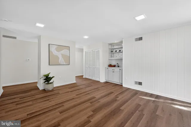 a bedroom with a bed and a potted plant