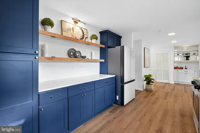 a kitchen with stainless steel appliances granite countertop a refrigerator and stove