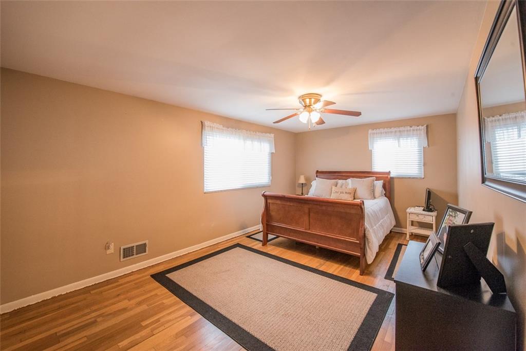 2371 Harrison City Road Export, PA 15632 - Photo 16 of 25 Large Bedroom, on Front of Home, measures 19x11 with Beautiful HW Floors, Ceiling Fan and Neutral Paint.