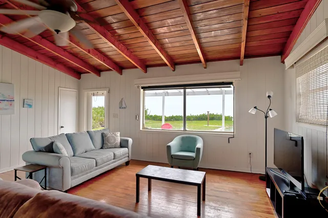 a bedroom with a large bed and a flat tv screen