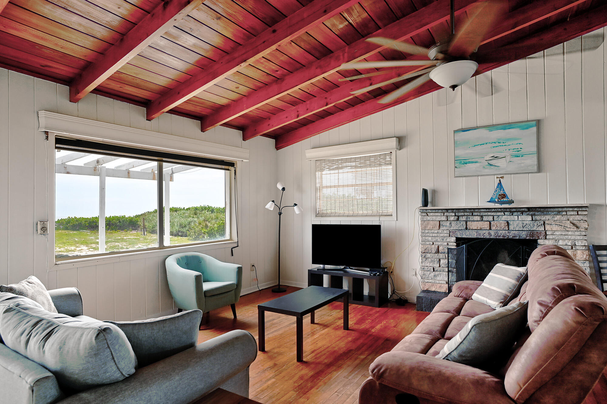 8517 Jimmy Buffett Mem Highway Melbourne Beach, FL 32951 - Photo 23 of 60 a living room with furniture a flat screen tv and a fireplace