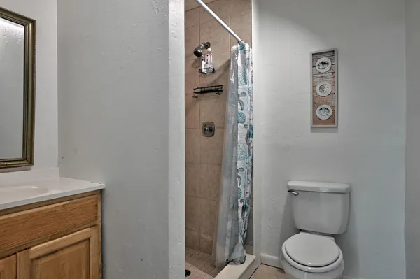 a white toilet sitting next to a bathroom sink and tub