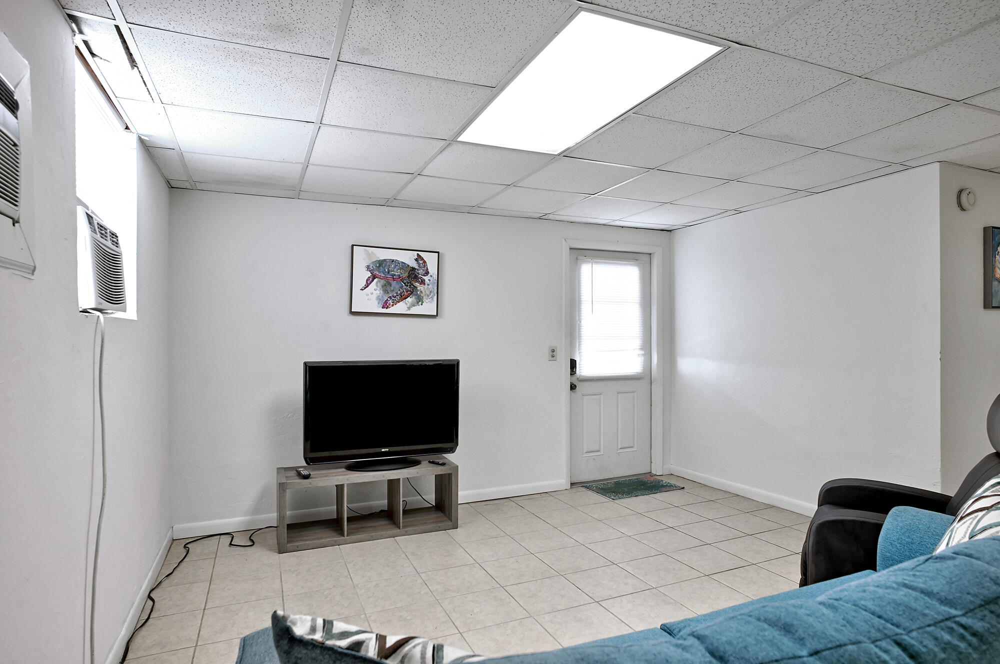 8517 Jimmy Buffett Mem Highway Melbourne Beach, FL 32951 - Photo 34 of 60 a living room with furniture and a flat screen tv