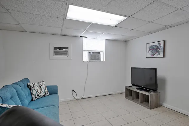 a white toilet sitting next to a bathroom sink and tub