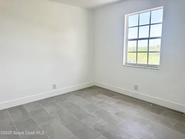 a living room with furniture a air conditioner vent and a window