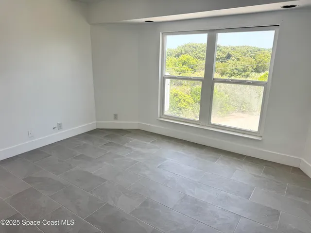 a living room with furniture a air conditioner vent and a window