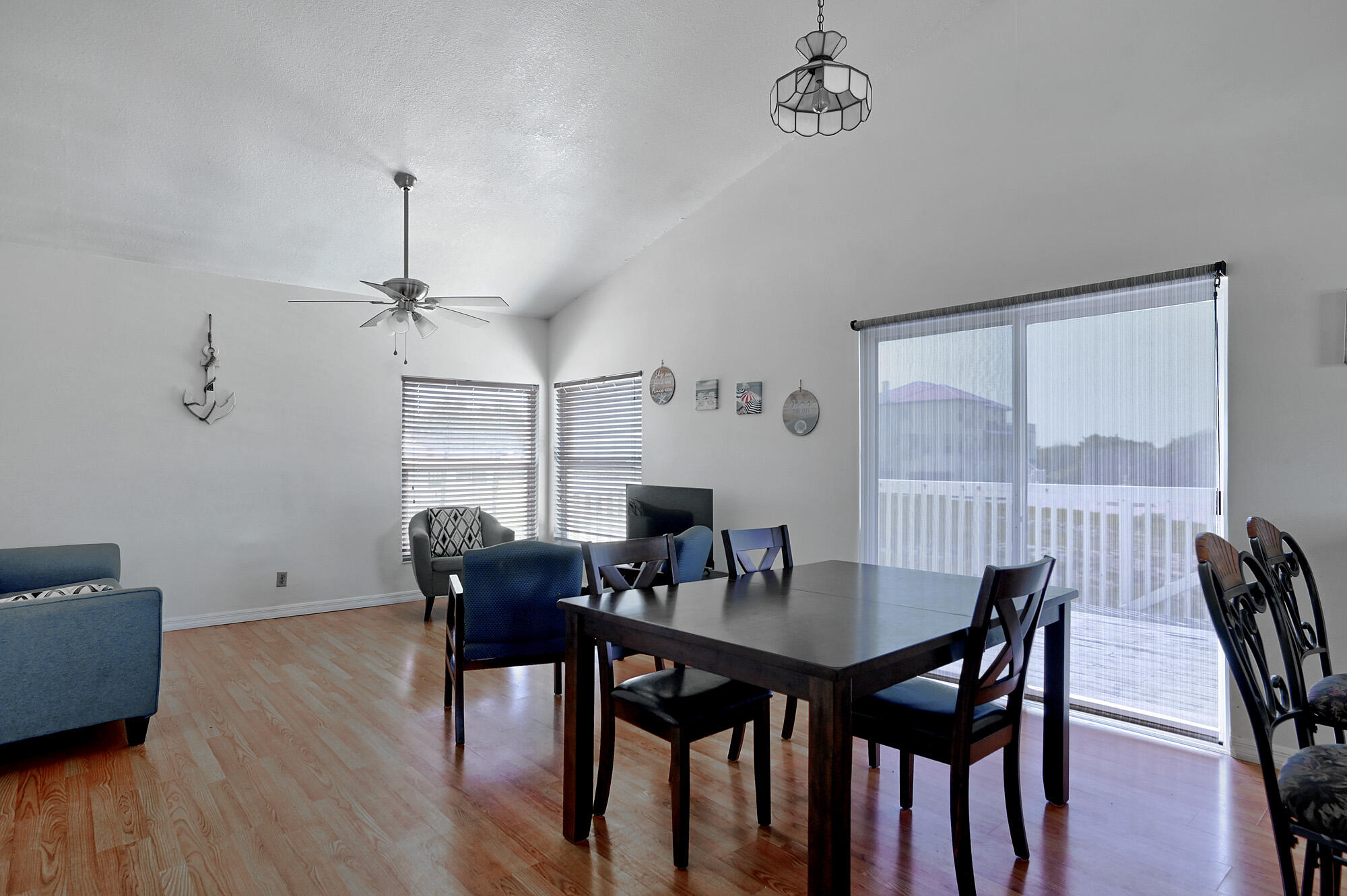 8517 Jimmy Buffett Mem Highway Melbourne Beach, FL 32951 - Photo 49 of 60 a view of a dining room with furniture window and wooden floor
