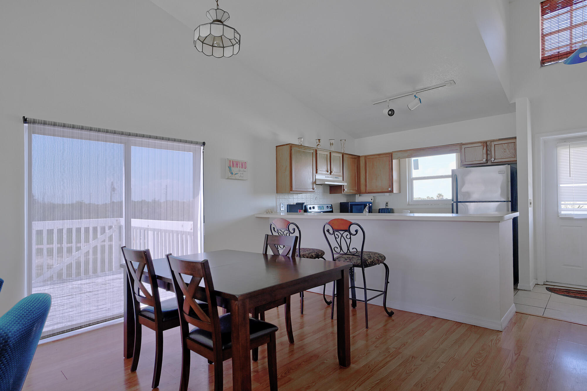 8517 Jimmy Buffett Mem Highway Melbourne Beach, FL 32951 - Photo 50 of 60 a view of a dining room with furniture and wooden floor