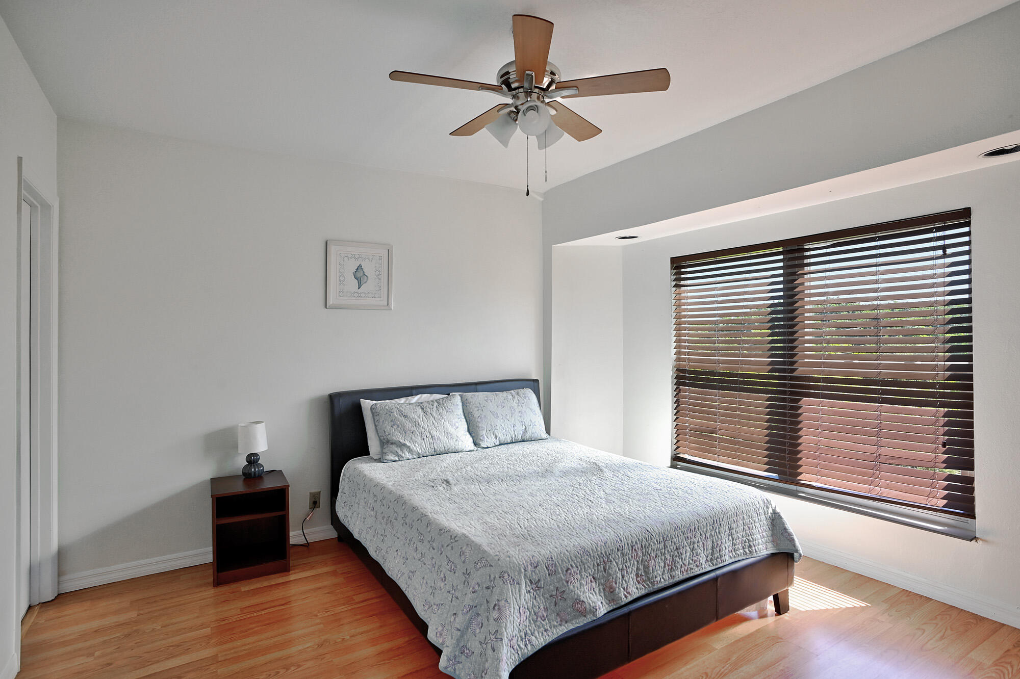 8517 Jimmy Buffett Mem Highway Melbourne Beach, FL 32951 - Photo 56 of 60 a bedroom with a bed and a chandelier